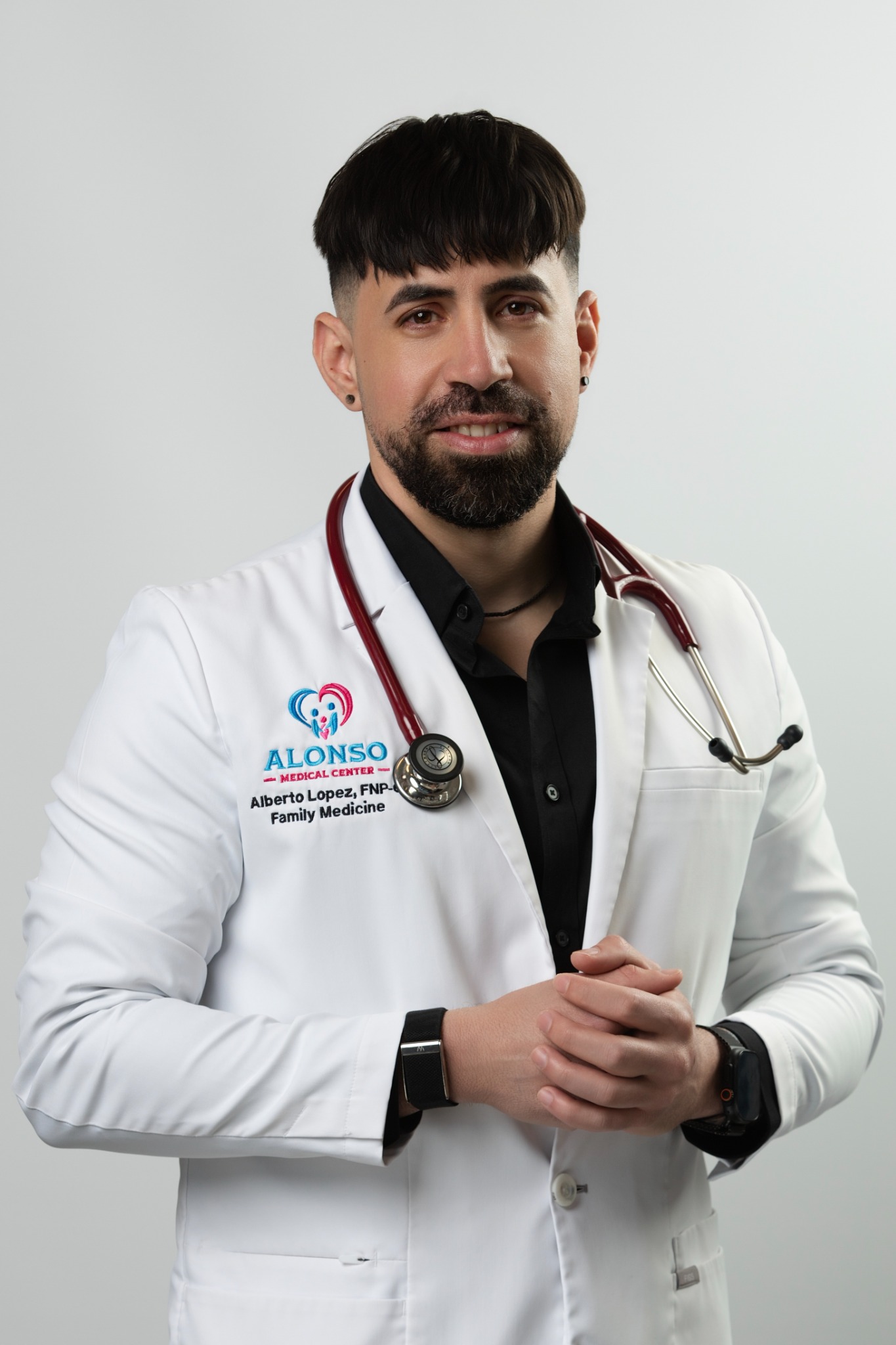Alberto Lopez, FNP-C, wearing his Alonso Medical Center white coat